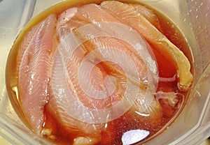 Tilapia fillets in marinade