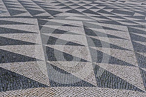 Tile brick floor in Lisbon, Portugal. Traditional old type mosaic on the sidewalk