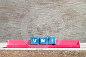 Tile letter on rack in word VMI abbreviation of vendor managed inventory on wood background