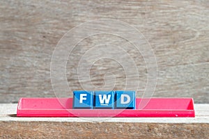 Tile letter on rack in word FWD Abbreviation of forward on wood background photo