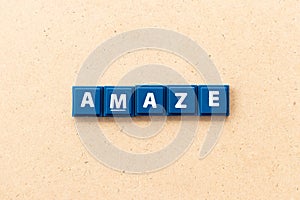 Tile letter in word amaze on wood background