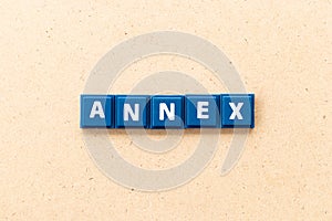 Tile letter in word annex on wood background