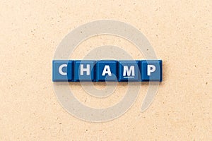 Tile letter in word champ on wood background