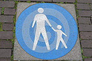 Tile In pavement showing pedestrian zone traffic sign