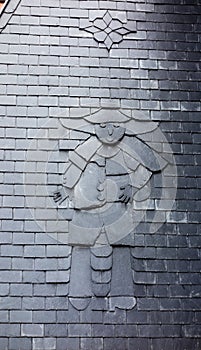 Tile person sculpted on roof tiles