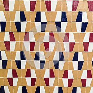 Tile of red, black, white and beige patterns.