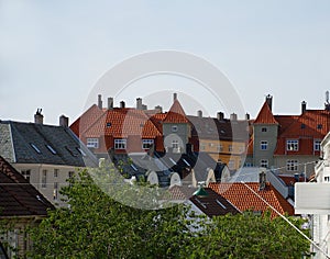 Tile roofs of Bergen, Norway and green street lamp