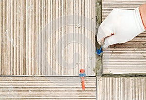 A tile`s hand places a plastic clip.