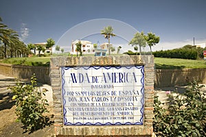 Tile sign along the Avenida de America reads, Ave. of America inaugurated by HH.MM the sovereigns of Spain Don Juan Carlos I and photo
