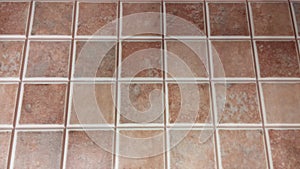 Tile texture with tiny squares and shades of brown