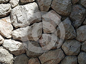 Tileable Stone wall texture seamless in half dark shadow