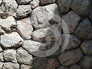 Tileable Stone wall texture seamless in half dark shadow