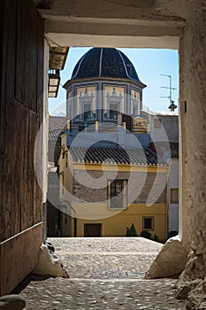 Tiled dome of the Parish Church of Our Lady of the Assumption through a porch, Onda, Castellon, Spain photo