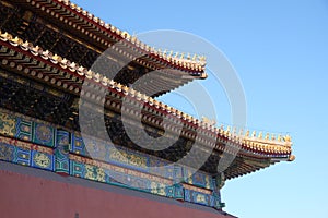 Tiled roof and facade decorated with a Chinese pattern. Palace in The Forbidden City, Beijing