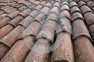 tiled roof supported on a double pitch roof, the old tiles tend to slip over time, because they are not fixed.