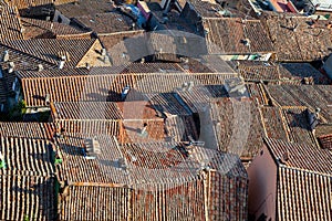 Tiled roofs and chimney pots of an ancient Italian town village. Soriano nel Cimino. Rooftop background