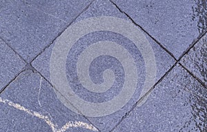 Tiled sidewalk pavement at rainy day. background, texture.