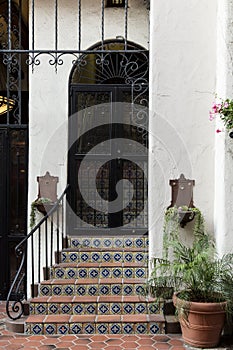 Tiled steps lead up to a metal door