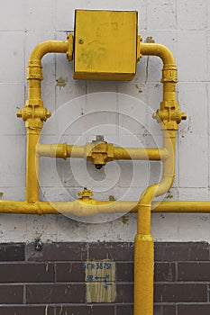 Tiled wall with a gas pipe valves