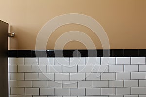 Tiled wall of a public toilet stall