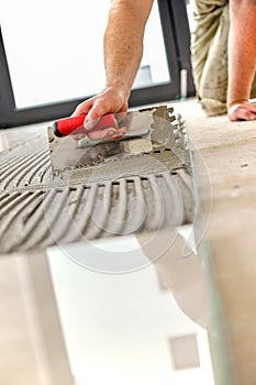 Tiler an the floor with a trowel