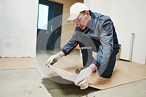 Tiler at indoor floor tiling renovation