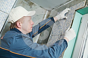 Tiler at indoor wall tiling renovation