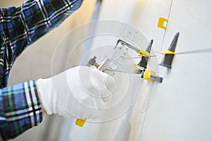 Tiler installing large format tile on wall. tile leveling system