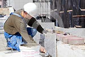 Tiler installing marble tiles