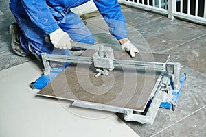 Tiler working with tile cutting equipment