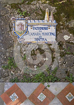 Tiles painted with `Patrimonio da Camara Municipal de Sintra` seen along Volta mounted on a brick wall in Sintra. photo