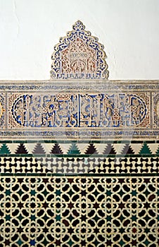Tiles and plasterwork. Wall decoration in the Mudejar Palace or Palace of King Don Pedro, Seville Andalusia Spain. photo
