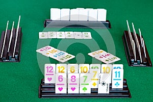 Tiles in rack and gameplay in Rummy on table