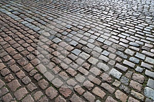 Tiles texture. Pattern of ancient german cobblestone in city downtown. Little granite paving stones. Antique gray pavements photo