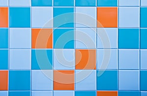 Tiles on wall in light blue, azure blue and orange