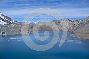 Tilicho Lake in Annapurna Conservation Area, Nepal, blue lake on mountain against sky