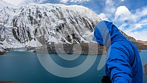 Tilicho Lake - A man taking a sefie at the shore of Tilicho lake in Himalayas