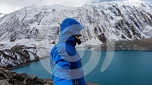 Tilicho Lake - A man taking a sefie at the shore of Tilicho lake in Himalayas