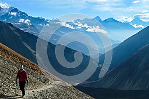 Tilicho Lake - A woman walking along a pathway towards the Tilicho Lake