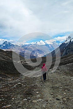 Tilicho Lake - A woman walking along a pathway towards the Tilicho Lake