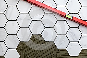 Tiling - laying marble texture hexagon tiles on the floor