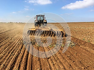 The tilling of farmland soil.