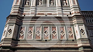 Tilt down of marble facade of Giotto bell tower, Cathedral of Saint Mary of the Flower, Florence, Italy