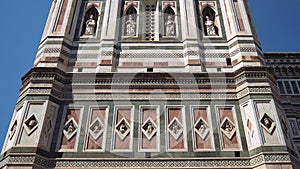 Tilt down of marble facade of Giotto bell tower, Cathedral of Saint Mary of the Flower, Florence, Italy