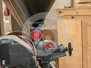 Tilt down shot of a machine rolling oats a working windmill