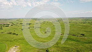 Tilt down shot of rolling hills and ranching farms