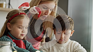 Tilt down video of family during Christmas baking.