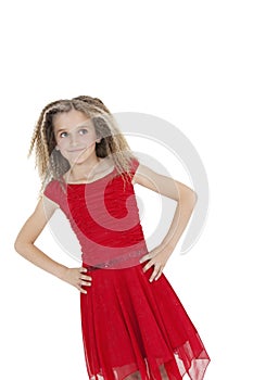 Tilt image of girl in red frock with hands on hips over white background