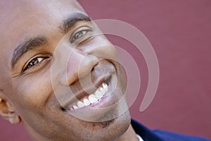 Tilt portrait of a happy African American man over colored background