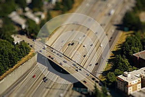 Tilt shift detail of bridge crossing interstate highway with cars